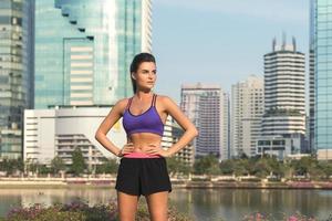 Fitness woman wearing sportswear in the modern city with skyscrapers photo