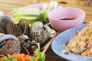 Close up of cooked blood clams on the table photo