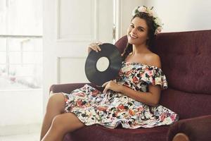 Happy woman with old vinyl record photo
