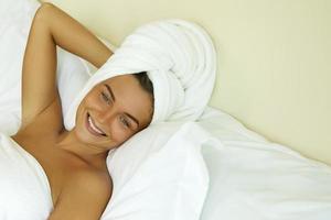 Woman is relaxing in bedroom after shower photo