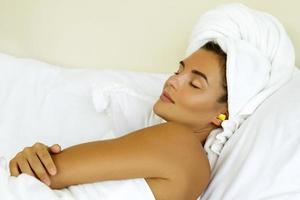 Woman in bedroom using earplugs for sleeping photo