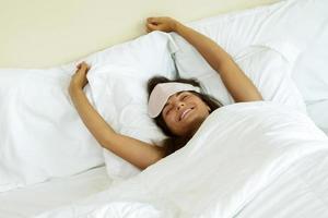 Happy woman waking up after good sleeping photo