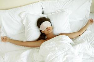 Woman is wearing eye mask and using earplugs photo