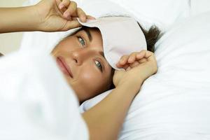 Happy woman waking up after good sleeping photo