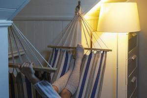 Woman wearing woolen stockings lying in the hammock photo