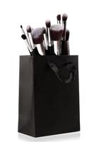 Professional makeup brushes in black shopping bag photo