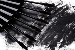 Close up of black brushes and smudged mascara photo