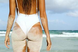 Female back and buttocks on the beach photo