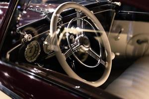 Steering wheel and part of interior of the retro photo