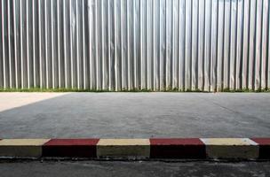 The construction site metal fence build beside the street footpath photo