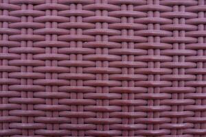 Knitted synthetic rattan material with traditional red cross texture for wallpaper and background. photo