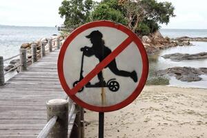 No scooter allowed sign at the beach wooden walkway. photo