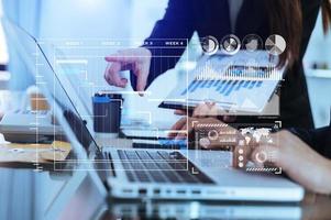 Businessman hand Project manager working and update tasks and Gantt chart scheduling virtual diagram.with smart phone, tablet and laptop in office. photo