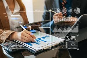 Businessman hand Project manager working and update tasks and Gantt chart scheduling virtual diagram.with smart phone, tablet and laptop photo