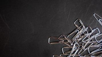 a paper clip on a black background photo