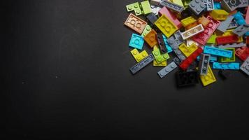 Plastic toy block on a black background photo