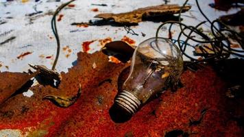 Light bulb on rusty zinc as a background photo