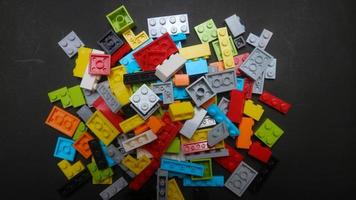 Plastic toy block on a black background photo