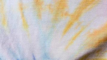 white cloth texture with yellow and blue patterns as background photo