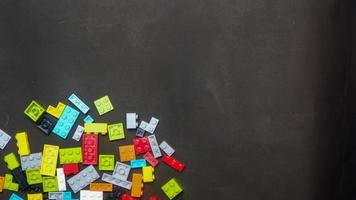 Plastic toy block on a black background photo