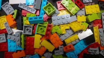 Plastic toy block on a black background photo