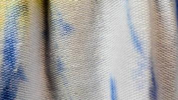 white cloth texture with yellow and blue patterns as background photo