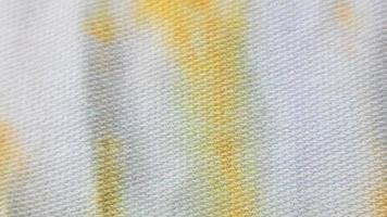 white cloth texture with yellow and blue patterns as background photo