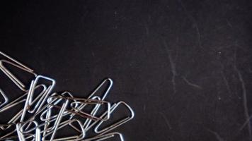 a paper clip on a black background photo