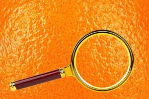 Cellulite, conceptual image of the texture of orange peel, skin with a magnifying glass. photo