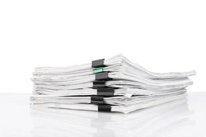 A stack of papers in the office on a white table, White isolated background. photo