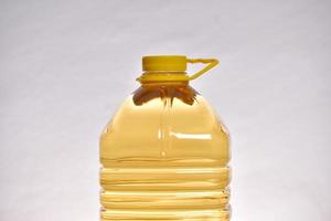 Macro photography of edible oil in transparent plastic bottle photo