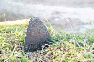 Hoe digging soil on the path in the field photo