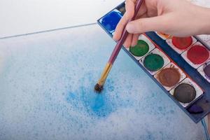 Watercolor paint dissolving in water photo