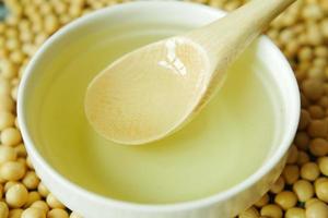 close up of Raw soy bean seed oil in a container photo