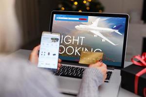 Flights online booking and reservation. woman working with a computer, search flights on the screen, office business background. photo