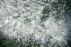 Water surface background with foam and bubbles photo