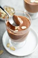 Chocolate pudding with sliced almonds photo