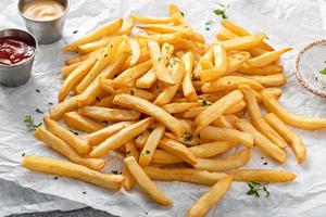Traditional french fries with ketchup and honey mustard sauce photo