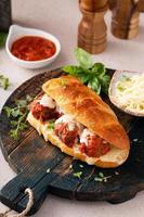 Meatball sub sandwich with marinara and mozzarella photo