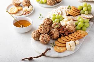 Cheese balls or truffles on a cheese board with crackers photo