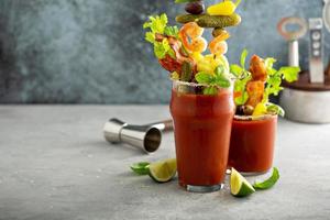 Bloody mary cocktail topped with various garnishes photo
