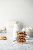 Sugar cookies with sprinkles and a bottle of milk photo