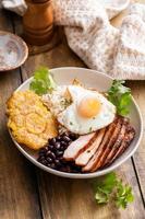 Caribbean or latin american breakfast with rice, beans and pork photo