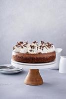 Chocolate cheesecake with whipped cream and chocolate shavings photo