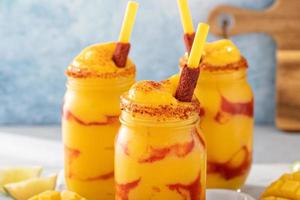 Mangonada mexican mango smoothie with chamoy sauce and lime seasoning photo