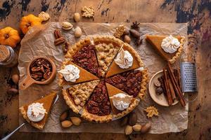 Traditional fall Thanksgiving pie slices, pumpkin and pecan pie photo