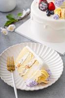 Vanilla cake for Mother's day with flowers and white chocolate glaze photo