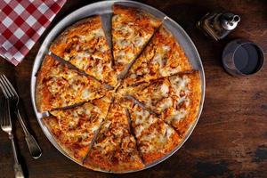 BBQ chicken pizza cut into slices photo