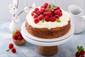 Simple summer cake with raspberries and frosting photo