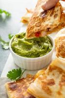Shrimp and cheese quesadillas served with guacamole photo